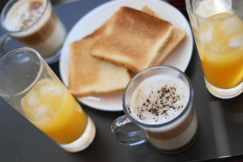 a table with two glasses of coffee and toast at Limay Bed&Breakfast in Neuquén