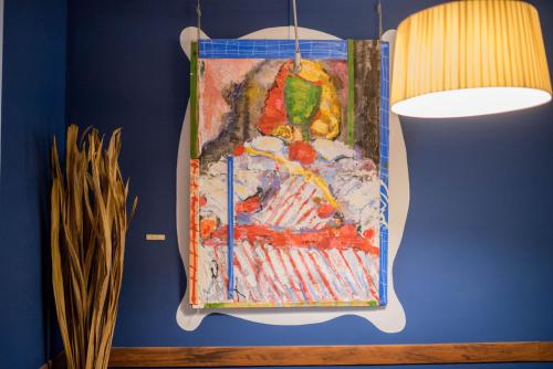 a painting of a parrot hanging on a wall at Hotel Almunia in Caravaca de la Cruz