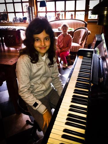 a young girl is sitting next to a keyboard at Brvnare Mrkic in Kremna