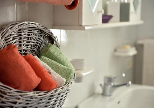 a basket of towels sitting next to a sink at Villa Metis in Realmonte