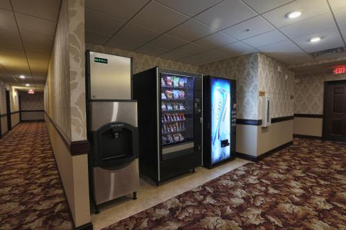 a vending machine in a room with a drink cooler at Arrow Hotel in Broken Bow