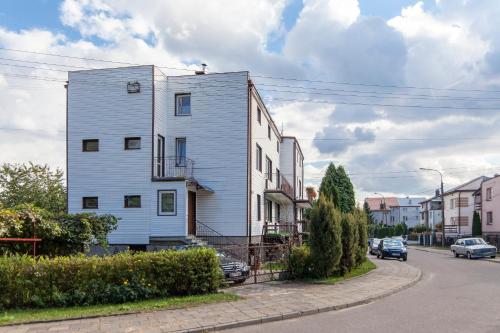 a white building on the side of a street at Peaceful Bialystok in Białystok