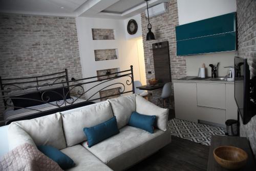 a living room with a white couch with blue pillows at Al Mattina Apartments Belgrade in Belgrade