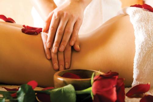 a woman is receiving aorative massage on her back at Olympic Residence Deluxe Apartments in Limassol