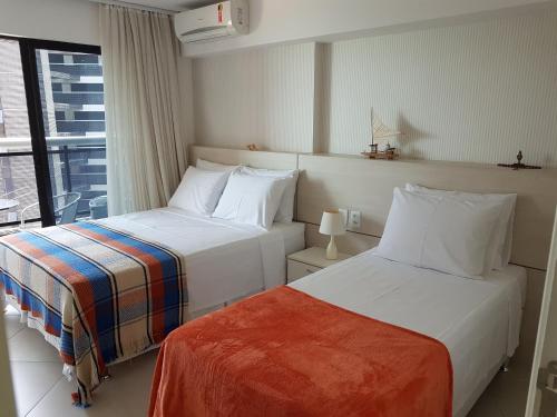 מיטה או מיטות בחדר ב-Landscape Beira mar