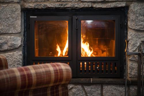 a fireplace in a stone wall with a fire in it at Åre Travel - Tottbacken in Åre