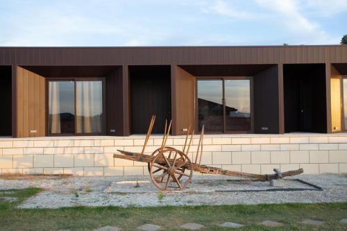a wooden wagon in front of a building at Quinta da Barroca Douro Valley in Armamar