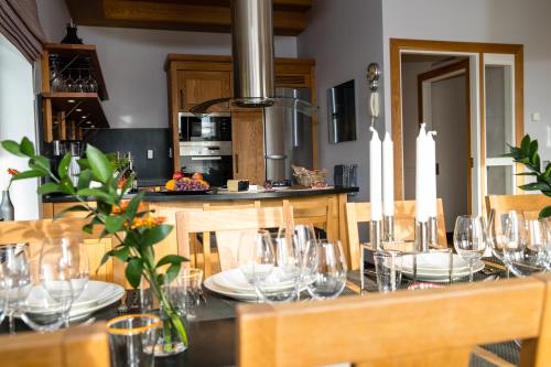 a dining room with a table with wine glasses at Åre Travel - Tottbacken in Åre
