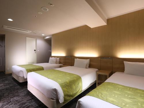 Кровать или кровати в номере Hotel Hokke Club Kyoto