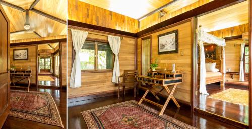 Habitación con escritorio y dormitorio con paredes de madera. en Rohotu Fare, en Bora Bora