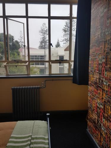a room with a bed and a window and a radiator at Archies Bunker Affordable Accommodation in Napier