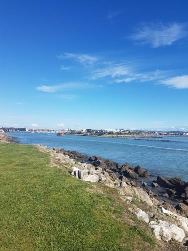 a view of a body of water with rocks at Archies Bunker Affordable Accommodation in Napier