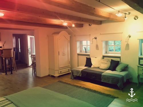 a living room with a bed and a table at Gute Stube in Weiden am See