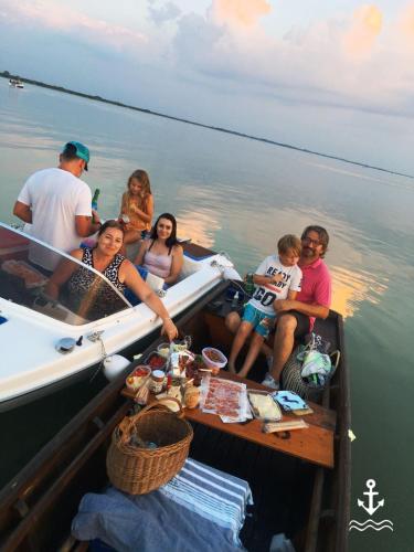 a group of people on a boat in the water at Gute Stube in Weiden am See