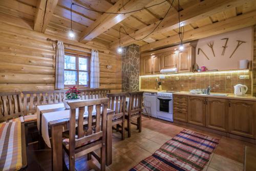 a kitchen with a table and chairs in a cabin at Chata Ilčík in Terchová