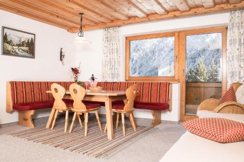 a dining room with a table and chairs and a window at Landhaus Maria in Neustift im Stubaital
