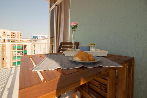 a wooden table with a plate of food on it at Oporto in Benicàssim