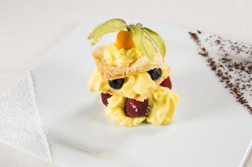 a piece of food on a white plate at Hotel Le Capanne in Arezzo