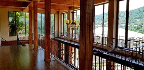 a room with a balcony with a view of the mountains at Philia's Guest House in Sighnaghi