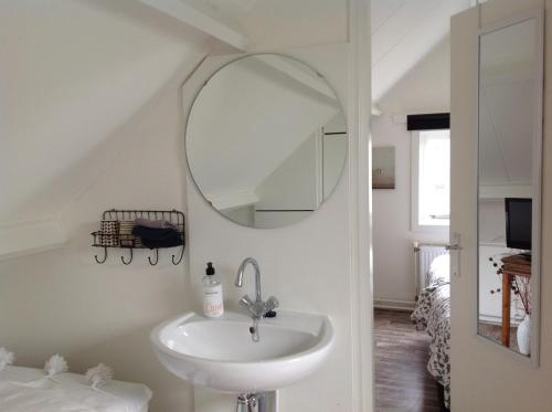 un baño con lavabo y espejo en Me Oissie, en Egmond aan Zee