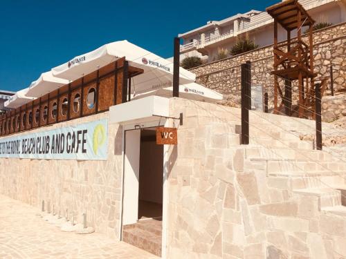 a building with a sign on the side of it at Sveti Luka Apartments in Dobra Voda