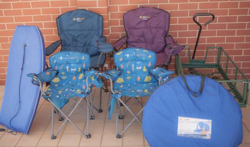 a group of chairs and umbrellas next to a brick wall at FortyTwo - Oceanside Retreat Busselton in Busselton