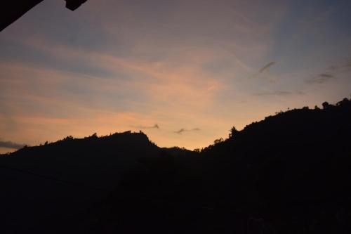 a silhouette of a mountain at sunset at Siddhartha Garden Ayurveda in Pokhara