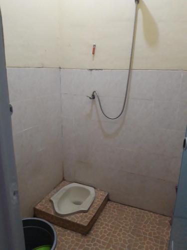 a bathroom with a toilet in a stall at Nusantara kost syariah bulanan harian in Kalasan