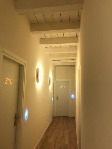 an empty hallway with white walls and wood floors at Palazzo Otello 1847 Wellness & Spa in Vicenza