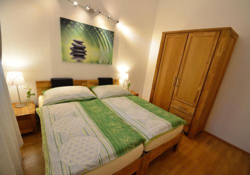 a bedroom with a bed and a painting on the wall at Haus Ferdinand in Fernitz
