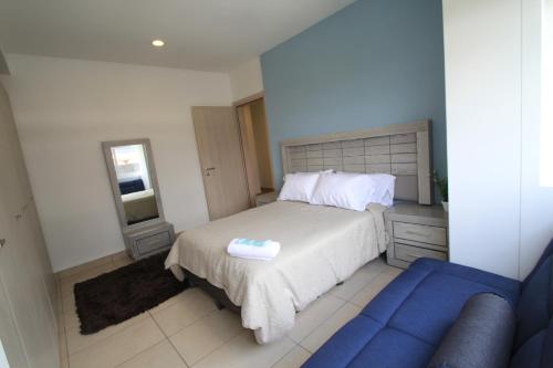 a bedroom with a bed and a blue couch at Boutique Apartment Downtown 707 two bedrooms in Mexico City