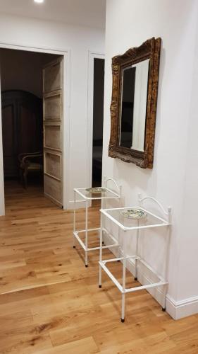 a room with two glass tables and a mirror at Villa mare Fontane Bianche in Fontane Bianche