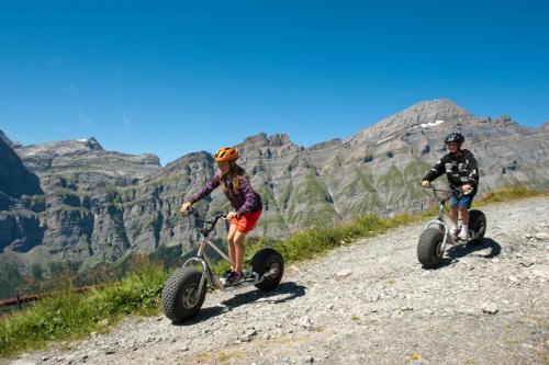 two people riding dirt bikes on a mountain trail at dala Hotel & Apartments in Leukerbad