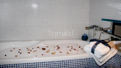 a bathroom with a bath tub filled with debris at casa rural EL RINCON in Navadijos