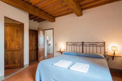 1 dormitorio con 1 cama con 2 toallas en Borgo Bottaia, en Grassina