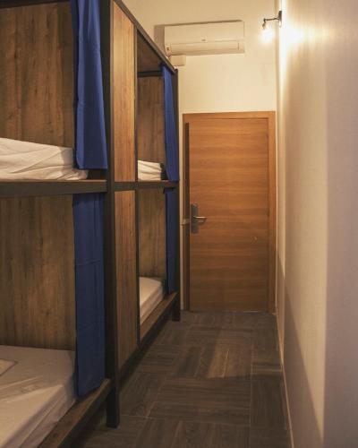 a room with a hallway with bunk beds and a door at The Market Hostel in Alicante