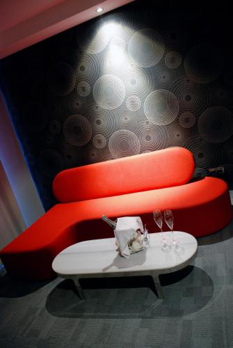 a table with two wine glasses on a wall at Met Hotel in Izmir