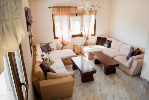 a living room with a couch and a table at Hotel Terelidis House in Varikón