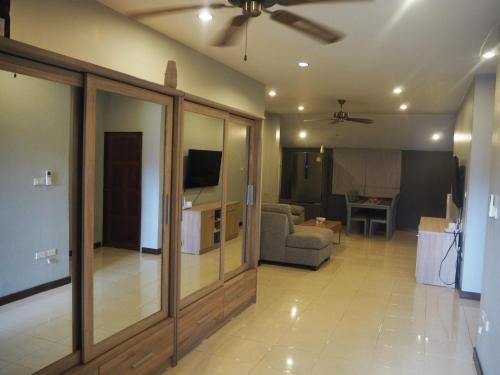 a living room with a couch and a ceiling fan at Beautiful 3 Bedroom Garden Villa in Chalong 