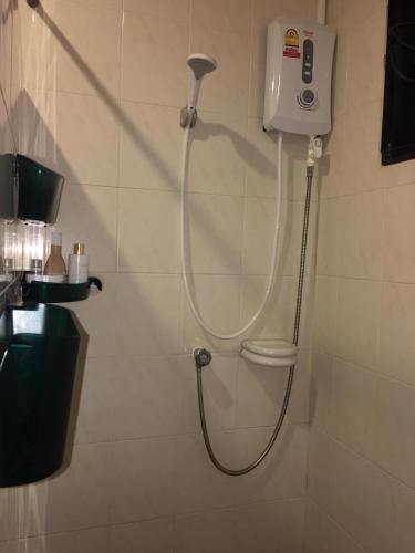 a shower in a bathroom with a shower head at 3BR Cozy House in Chalong