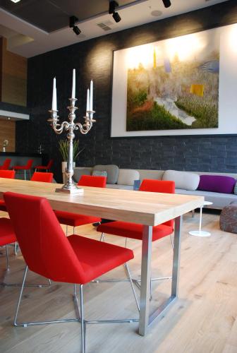 a dining room with a table and red chairs at Met Hotel in Izmir