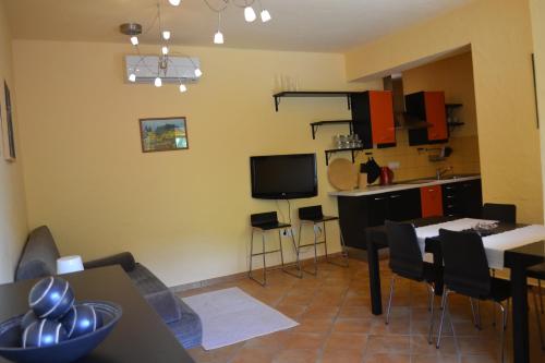 a living room with a dining table and a kitchen at Počitniška hiša Lazar in Kobarid