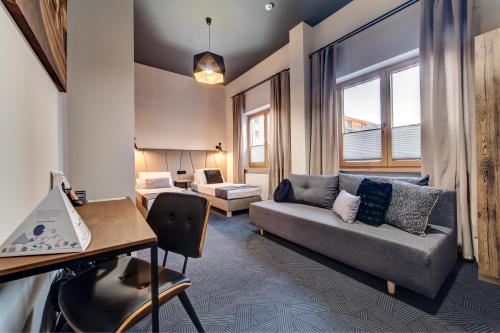 a living room with a couch and a table at GoldApartRooms in Białystok