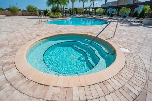 a swimming pool in a resort with blue water at Dream Vacation Home! in Kissimmee