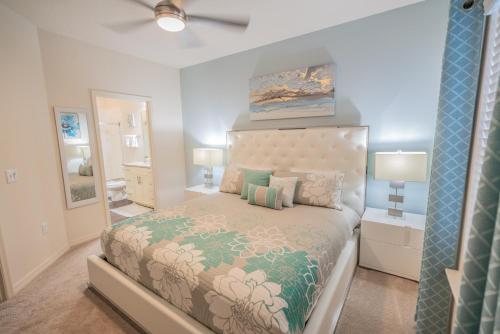 a bedroom with a large bed and a mirror at Dream Vacation Home! in Kissimmee
