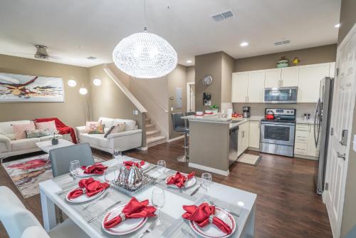 a kitchen and living room with a dining table and a kitchen at Dream Vacation Home! in Kissimmee