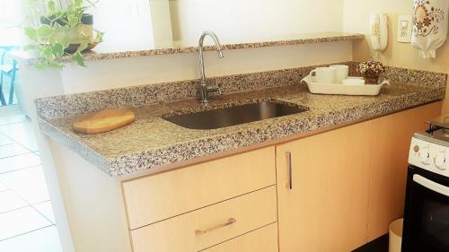 a kitchen with a sink and a counter top at Beach Class Rosalux in Fortaleza