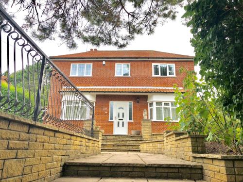 a brick house with a staircase in front of it at St Marys House in Norwich