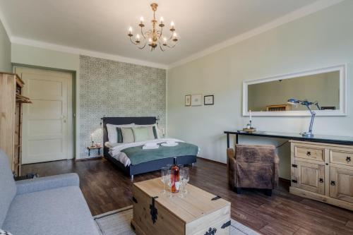 a bedroom with a bed and a chandelier at APT with sunny garden Prague by Michal&Friends in Prague