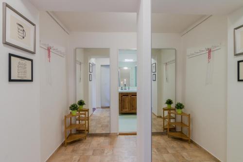 a hallway with white walls and a hallway with a kitchen at APT with sunny garden Prague by Michal&Friends in Prague
